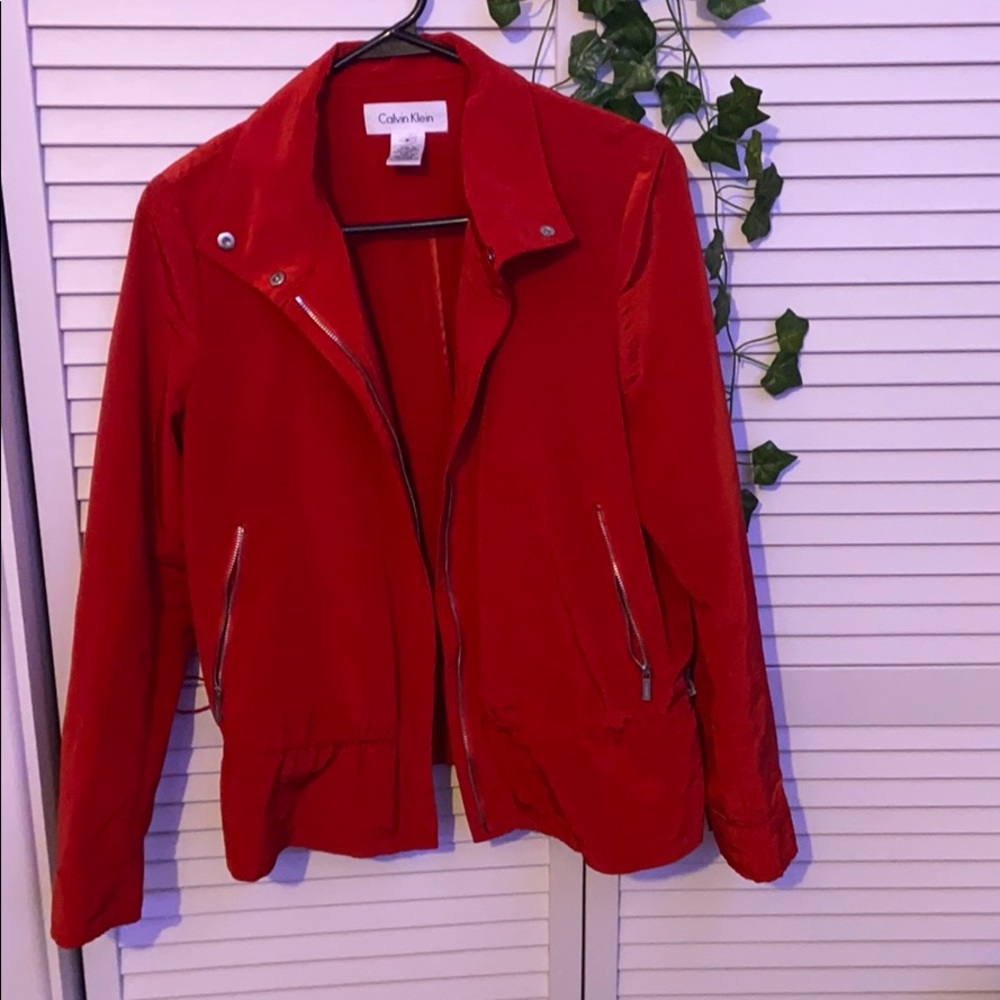 Red Calvin Klein raincoat